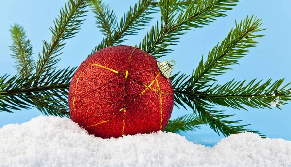 Christmas tree branch, Christmas balls, and white snow — Stock Photo, Image