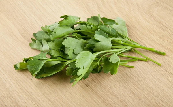 Fresh parsley on a wooden background — Stock Photo, Image