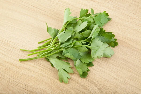Fresh parsley on a wooden background — Stock Photo, Image