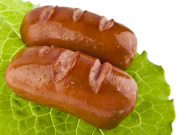 Sausage and lettuce leaf isolated on white background — Stock Photo, Image