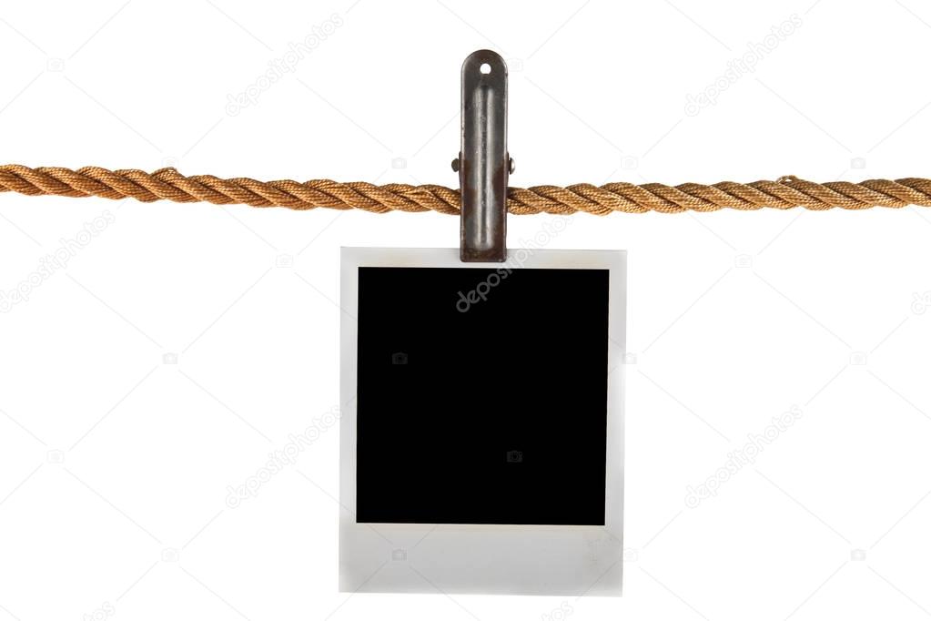 Old photo on a rope isolated on a white background