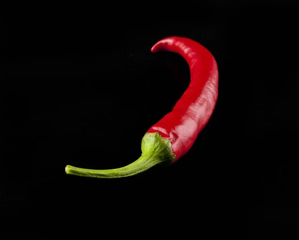 Red hot pepper on a black background closeup — Stock Photo, Image