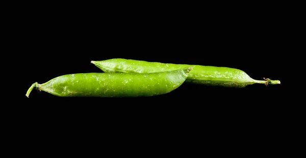 Green peas on a black background close-up — Stock Photo, Image