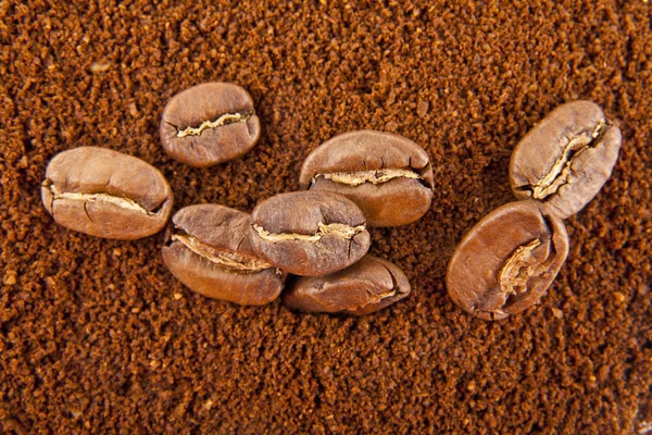 grains and ground coffee as background