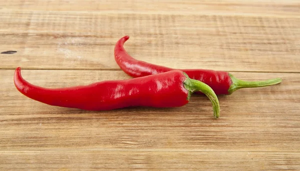 Red hot pepper on a wooden background — Stock Photo, Image