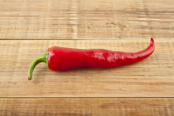 Red pepper on a wooden background — Stock Photo, Image