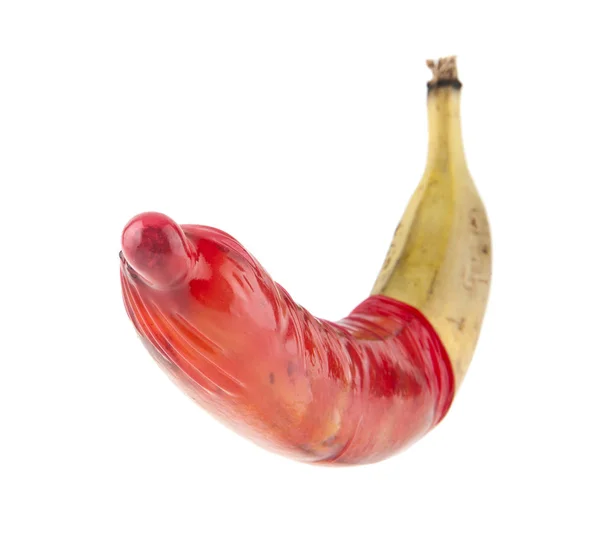 Red condom and old, ripe banana isolated on white background — Stock Photo, Image