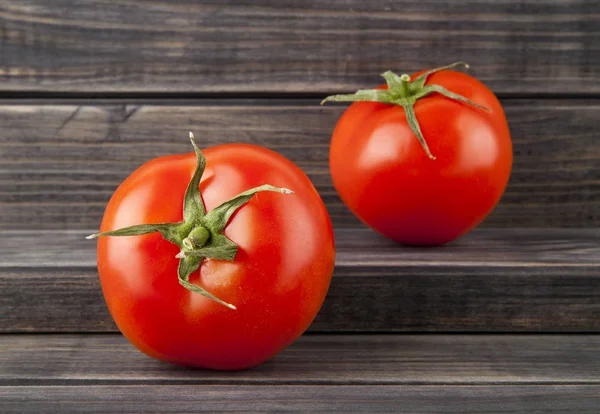 Juicy tomatoes on a wooden background — Stock Photo, Image