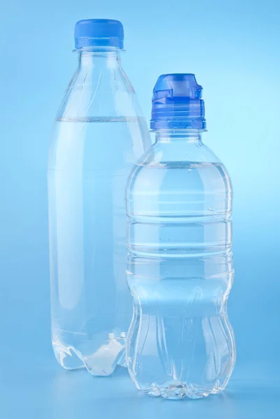 Bottles of water on a blue background — Stock Photo, Image