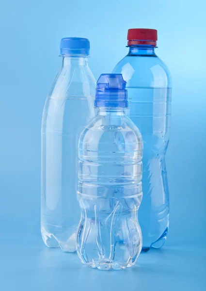 Bottles of water on a blue background — Stock Photo, Image