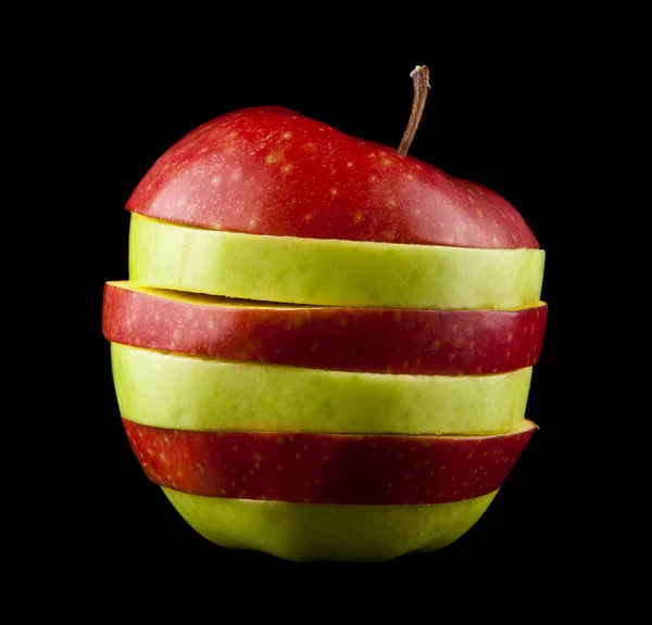 Cut red and green apple on a black background — Stock Photo, Image
