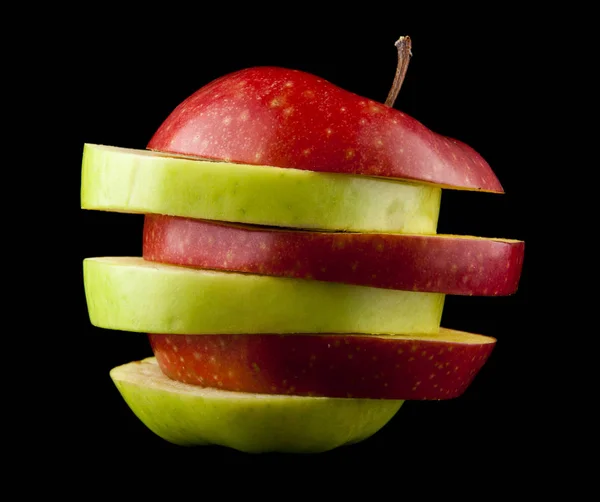 Cut red and green apple on a black background — Stock Photo, Image