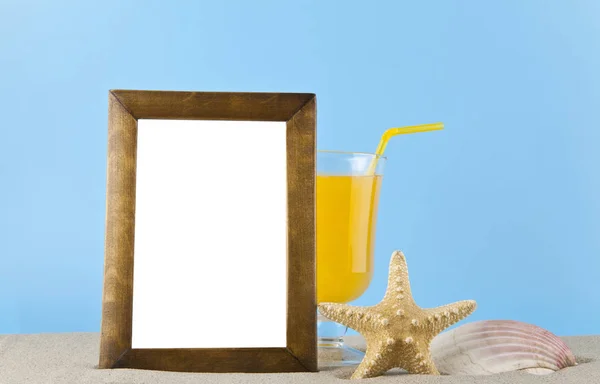 Starfish, shell, orange juice and photo frame in the sand for re — Stock Photo, Image