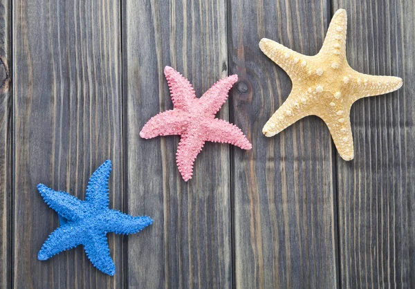 Sea stars on a wooden background — Stock Photo, Image