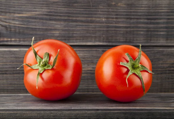 Pomodori rossi, succosi, freschi su fondo di legno — Foto Stock