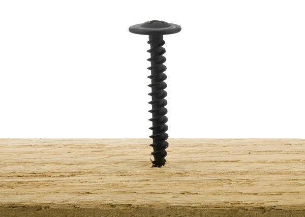 Tornillo de metal negro atornillado en una tabla de madera aislada en un blanco — Foto de Stock