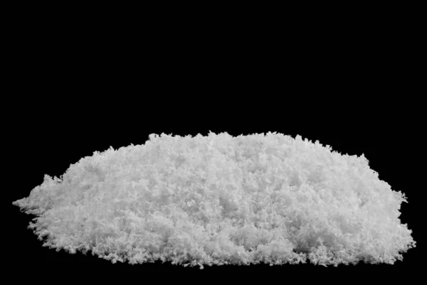 A pile of white fluffy snow isolated on a black background. — Stock Photo, Image