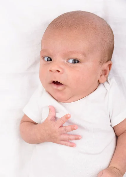 Newborn baby on white sheet — Stock Photo, Image