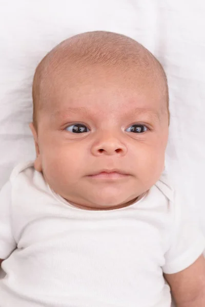 Newborn baby on white sheet — Stock Photo, Image