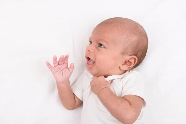 Newborn baby on white sheet — Stock Photo, Image