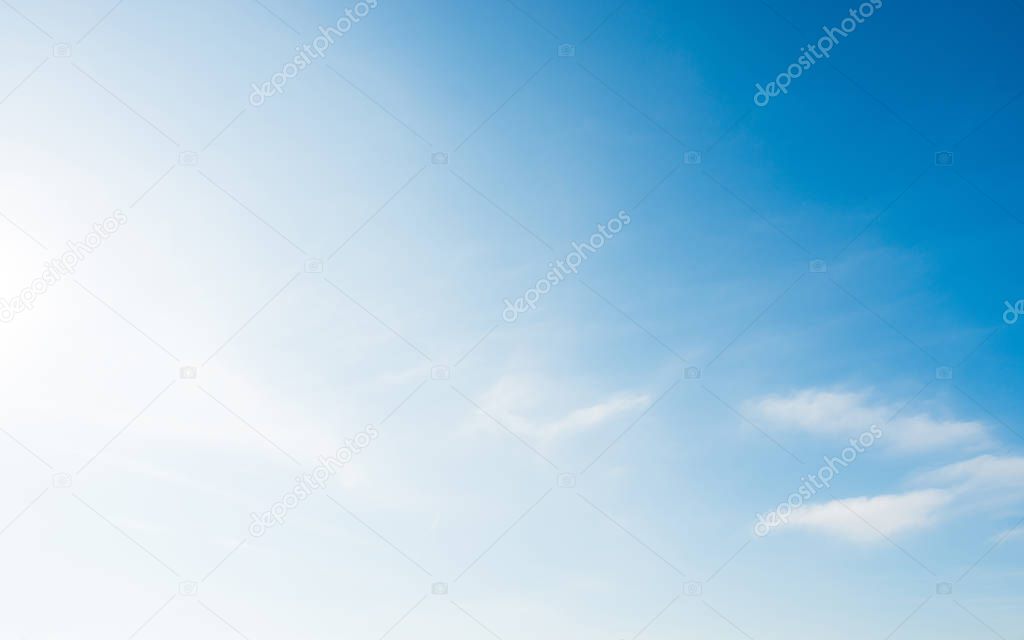 Bright and soft blue sky with small white clouds