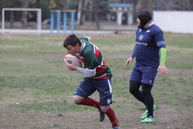 Odessa, Ukrayna 24 Kasım 2019: Rugby Derbisi turnuvasında yerel ragbi kulüpleri yeşil donanımsız sahada şiddetli bir kavgaya tutuştu. Rugby atletlerinin stadyum açıklamalarında şiddetli çatışmalar yaşandı. Savaş