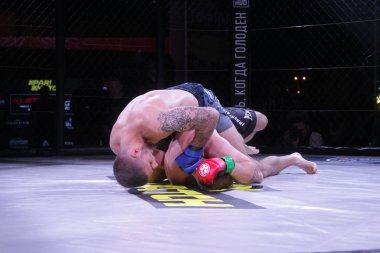 Odessa, Ukrayna-Haziran 30, 2019: Mma boksörler Fighters sekizgenkafes halka kuralları olmadan mücadele ediyor. Mma dövüşçüleri şampiyonada ringde. Metal kafes ten kuralsız boks kavgaları bak