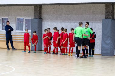 Odessa, Ukrayna-12 Aralık 2019: Küçük çocuklar ve çocuklar spor salonunda küçükler şampiyonasında mini futbol oynuyorlar. Çocuk sporu sağlıklı bir yaşam tarzıdır. Sporcu çocuklar futbol oyuncuları