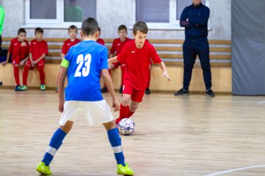 Odessa, Ukrayna-12 Aralık 2019: Küçük çocuklar ve çocuklar spor salonunda küçükler şampiyonasında mini futbol oynuyorlar. Çocuk sporu sağlıklı bir yaşam tarzıdır. Sporcu çocuklar futbol oyuncuları