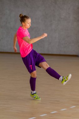 ODESSA, UKRAINE - March 13, 2020: Futsal Cup of Ukraine, futsal among students. During final match in futsal among student teams. Beautiful sports girls play mini football on parquet floor
