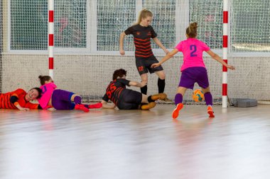ODESSA, UKRAINE - March 13, 2020: Futsal Cup of Ukraine, futsal among students. During final match in futsal among student teams. Beautiful sports girls play mini football on parquet floor