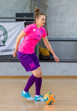 ODESSA, UKRAINE - March 13, 2020: Futsal Cup of Ukraine, futsal among students. During final match in futsal among student teams. Beautiful sports girls play mini football on parquet floor