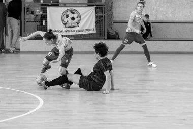 ODESSA, UKRAINE - March 13, 2020: Futsal Cup of Ukraine, futsal among students. During final match in futsal among student teams. Beautiful sports girls play mini football on parquet floor