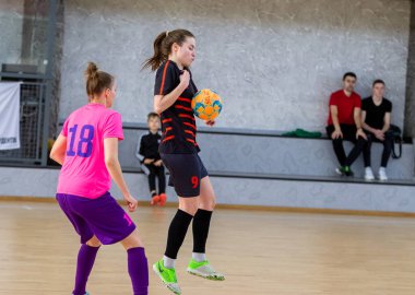 ODESSA, UKRAINE - March 13, 2020: Futsal Cup of Ukraine, futsal among students. During final match in futsal among student teams. Beautiful sports girls play mini football on parquet floor