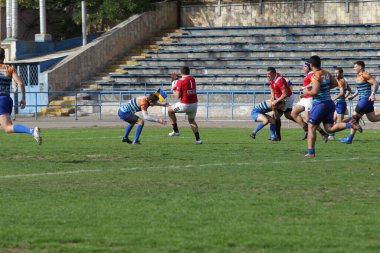 ODESSA, UKRAINE - SEPT 20, 2017: CREDO-Odessa Rugby Şampiyonası Milli Takımı - Politeknik-Kiev. Rugby oyuncularının top için yoğun mücadelesi. Stadyumun yeşil sahasında dinamik oyun