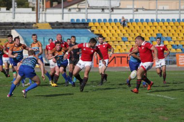 ODESSA, UKRAINE - SEPT 20, 2017: CREDO-Odessa Rugby Şampiyonası Milli Takımı - Politeknik-Kiev. Rugby oyuncularının top için yoğun mücadelesi. Stadyumun yeşil sahasında dinamik oyun