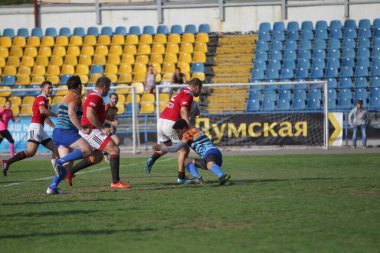 ODESSA, UKRAINE - SEPT 20, 2017: CREDO-Odessa Rugby Şampiyonası Milli Takımı - Politeknik-Kiev. Rugby oyuncularının top için yoğun mücadelesi. Stadyumun yeşil sahasında dinamik oyun