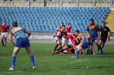 ODESSA, UKRAINE - SEPT 20, 2017: CREDO-Odessa Rugby Şampiyonası Milli Takımı - Politeknik-Kiev. Rugby oyuncularının top için yoğun mücadelesi. Stadyumun yeşil sahasında dinamik oyun