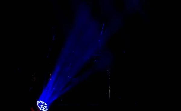 Stage lights. Background in show. Light spotlight in the dark. The interior of the theater scene is illuminated to the projector. Stage lights and stage smoke during the concert
