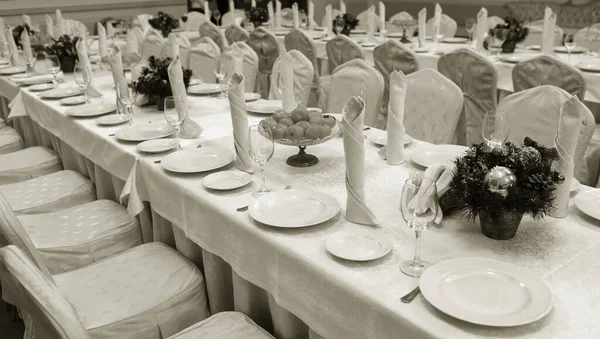 Festive table setting background. Serving a large festive restaurant table in anticipation of guests in a soft dim light.