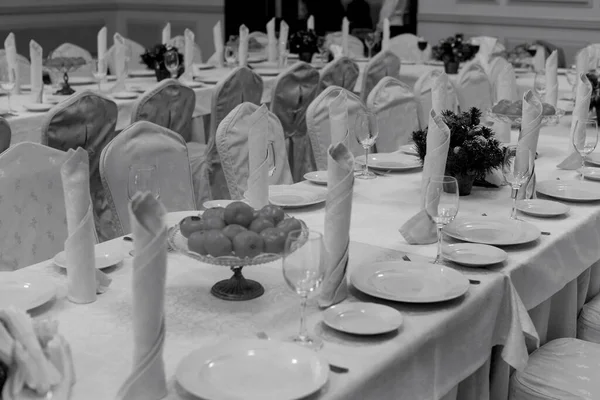 お祭りのテーブル設定の背景 柔らかい薄明かりの中でお客様を見越して大きなお祝いのレストランテーブルを提供しています — ストック写真