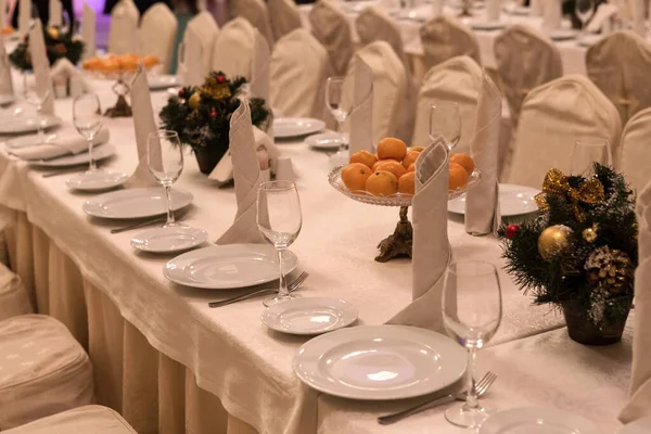 Festive table setting background. Serving a large festive restaurant table in anticipation of guests in a soft dim light.