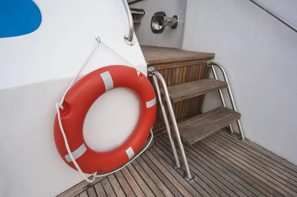 Safety life ring and steps on deck of a yacht