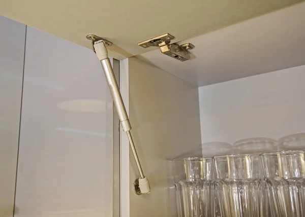 Closeup detail of a hinge on kitchen cupboard — Stock Photo, Image