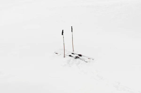 Pair of skis in snow white background