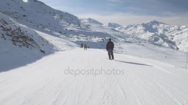 Skiers on piste going downhill — Stock Video