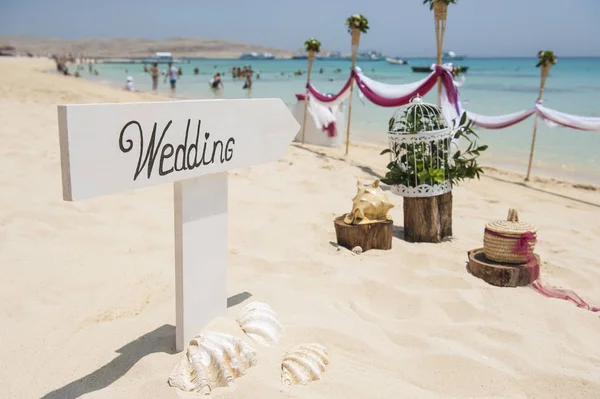 Wooden wedding sign on tropical sandy beach