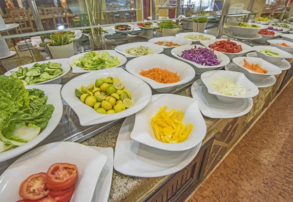 Keukenspullen voor salade eten bij een restaurant buffet — Stockfoto
