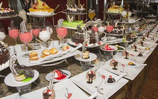 Selection of desserts on display at a restaurant buffet — Stock Photo, Image