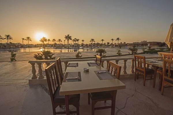 Outdoor dining table  with sunset in tropical hotel resort — Stock Photo, Image